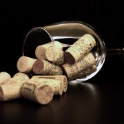 A wine glass on its side filled with corks