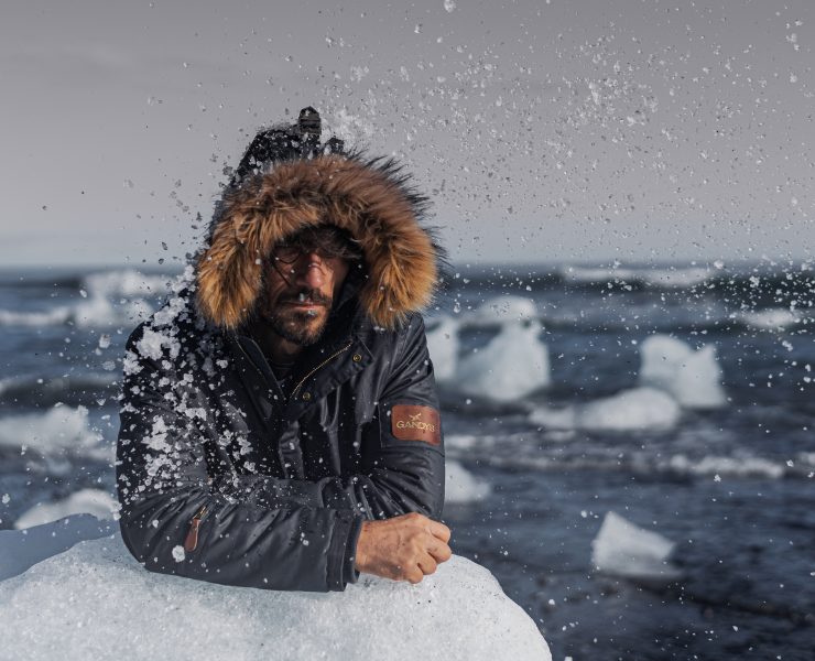 A model rests on a piece of ice during a photoshoot for Gandys London