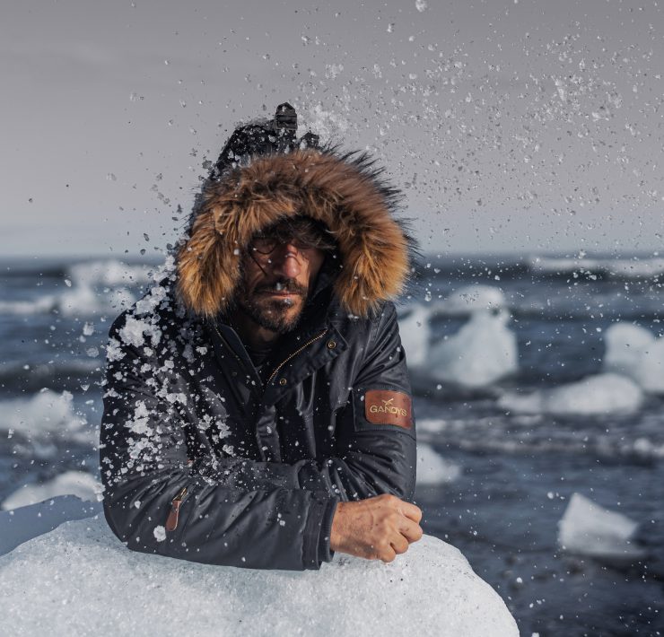 A model rests on a piece of ice during a photoshoot for Gandys London