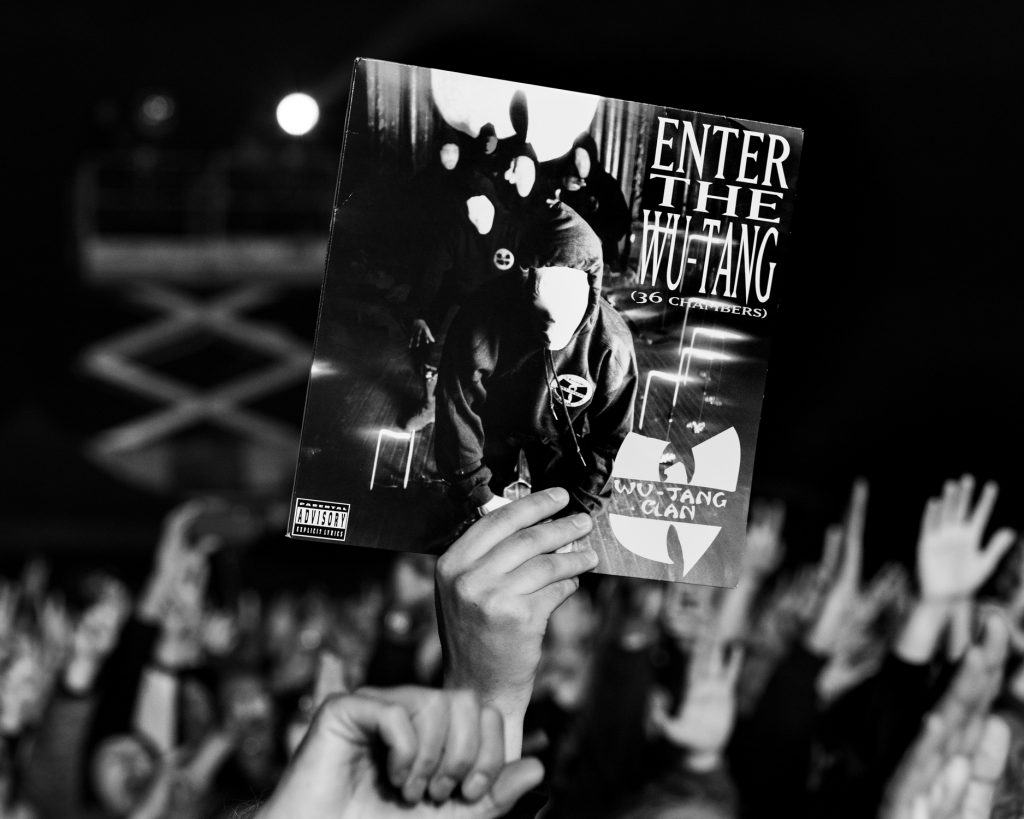 Fan at Gods of Rap tour holding up a copy of Enter the Wu-Tang