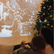 Child watching xmas film on projector
