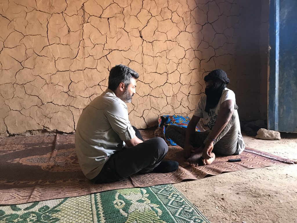 Reza Interviewing a migrant in a Ghetto in Agadez