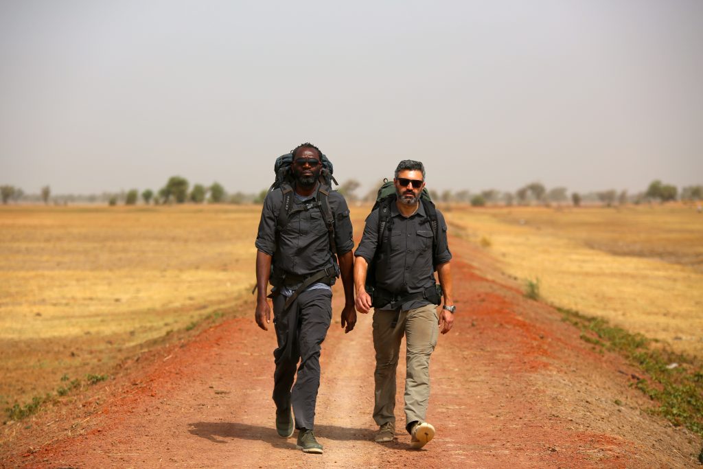 Reza Pakraven walking in Mali with a local guide