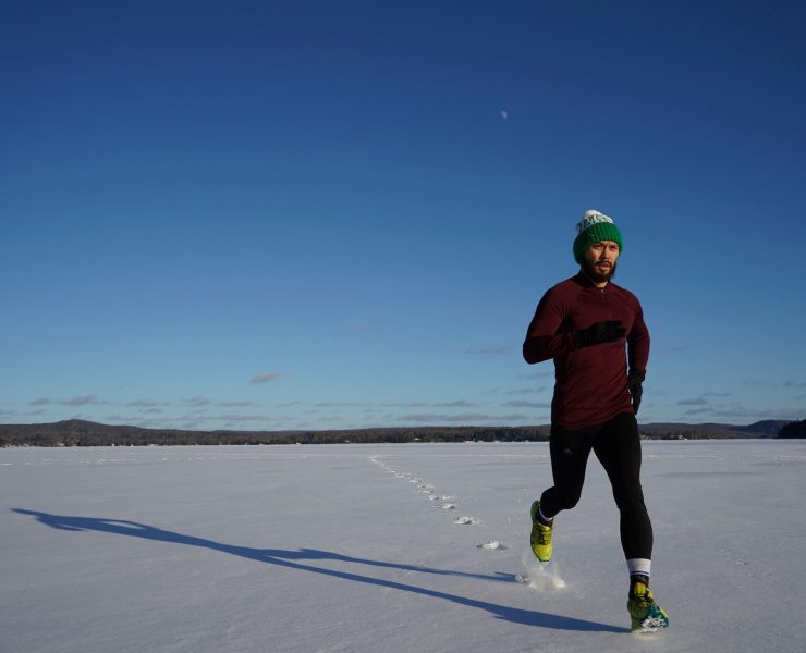 Man running on ice covered land