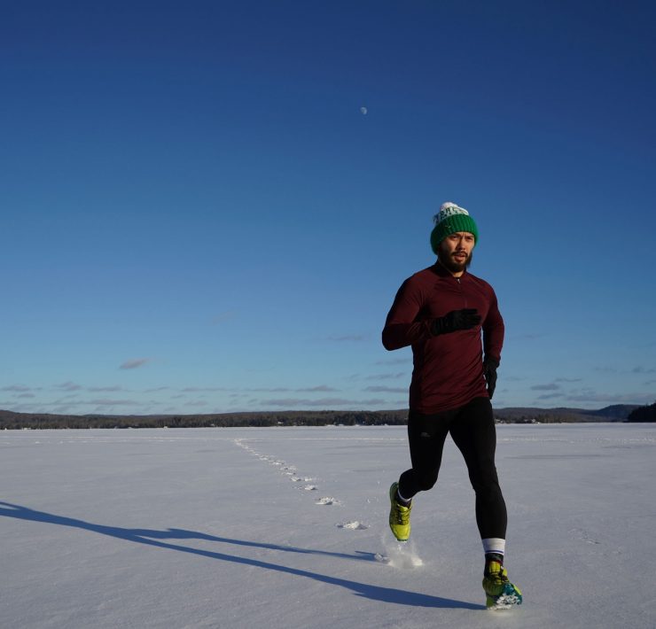 Man running on ice covered land