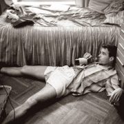 Man drunk on the floor clutching a bottle