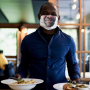 Man serving food with face mask on
