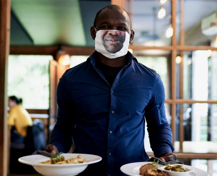 Man serving food with face mask on