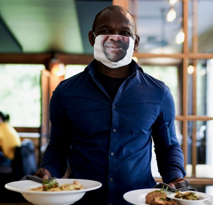 Man serving food with face mask on