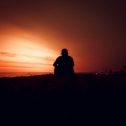 man sat watching sunset