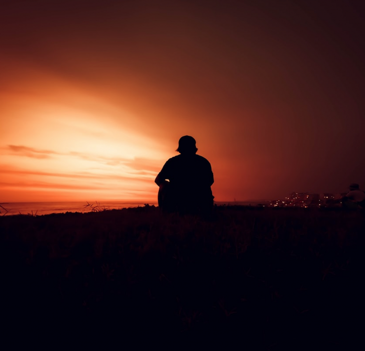 man sat watching sunset
