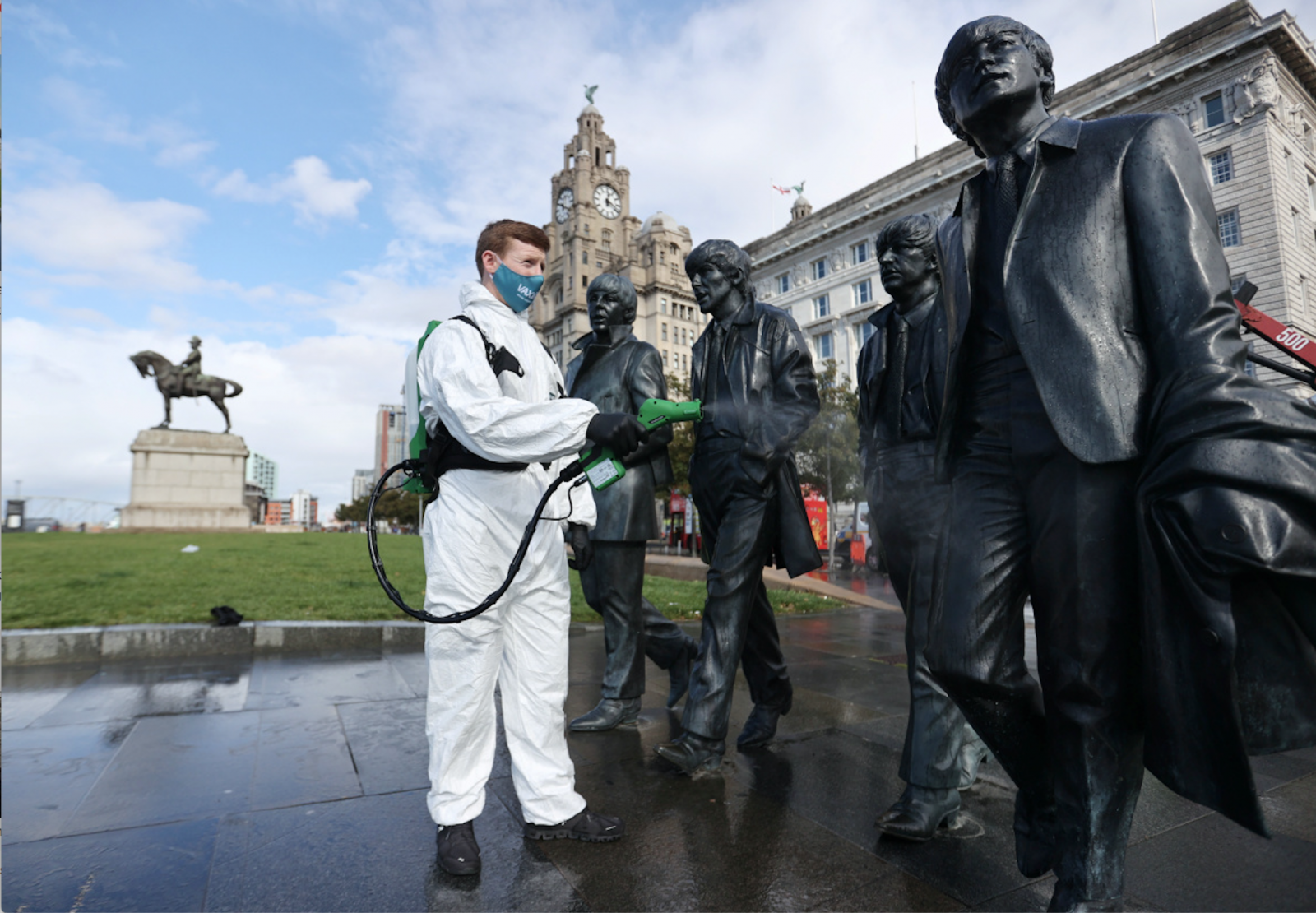 spraying the beatles statue in front of liver building