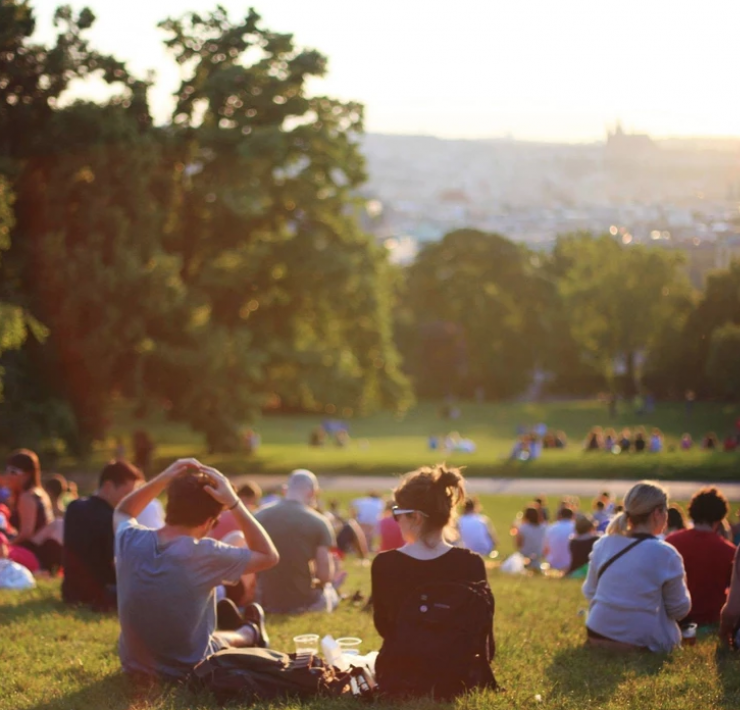 Groups of people sat in a park