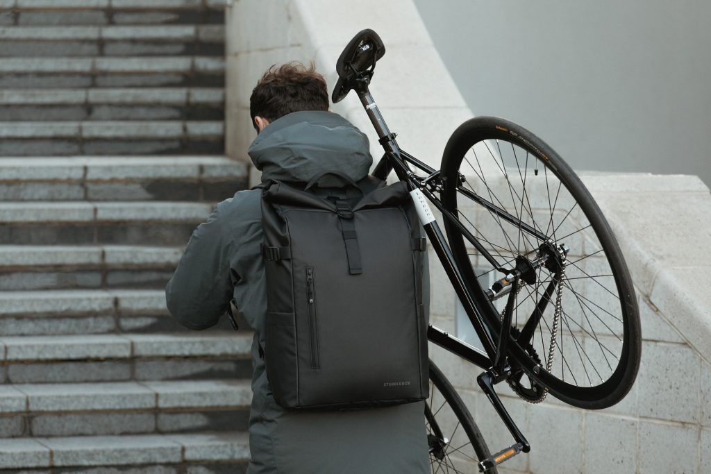 Stubble & Co bag worn by man carrying bike