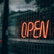 Open sign behind wire grill