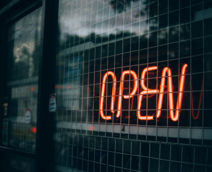 Open sign behind wire grill