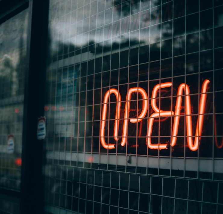 Open sign behind wire grill