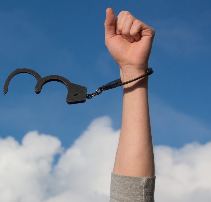 Person throwing off their handcuffs