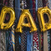 'DAD' written in balloons in front of lots of ties