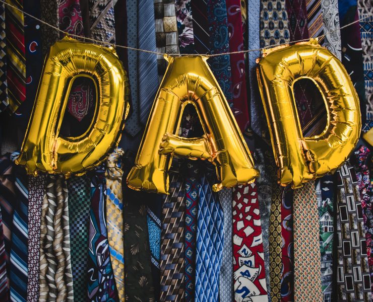 'DAD' written in balloons in front of lots of ties