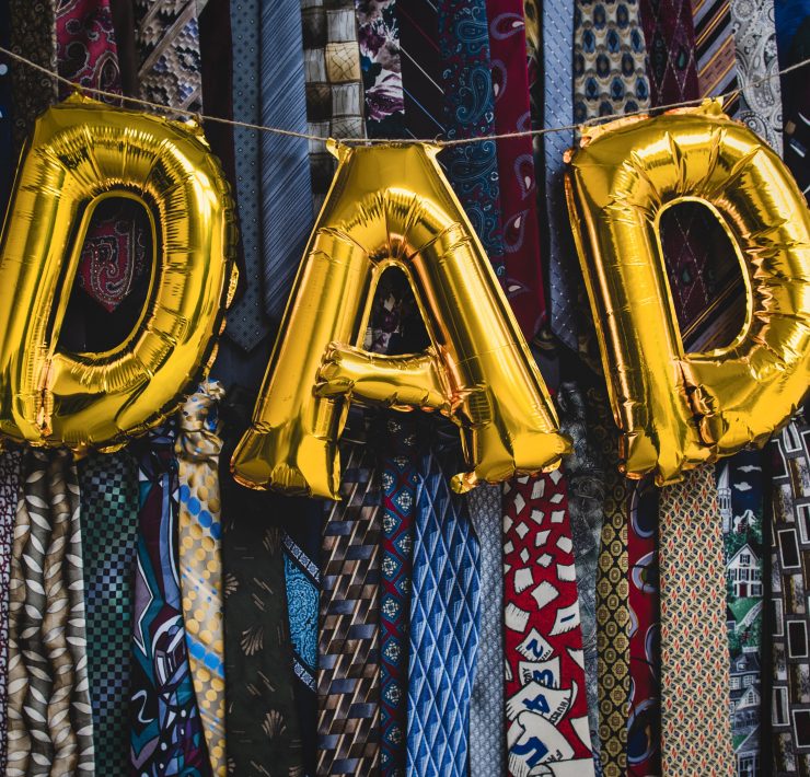 'DAD' written in balloons in front of lots of ties