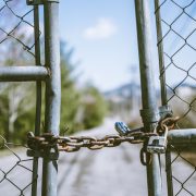 Padlocked gate in front of a road