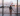 Girl in airport looking through a window at a British airways plane