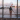 Girl in airport looking through a window at a British airways plane