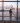 Girl in airport looking through a window at a British airways plane