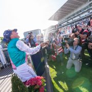 Jockey celebrating St Leger win at Doncaster racecourse