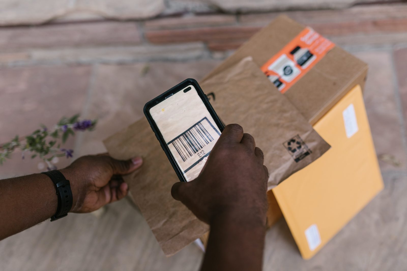 Courier scanning a parcel's barcode