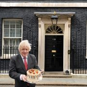 boris johnson holding a cake outside downing street