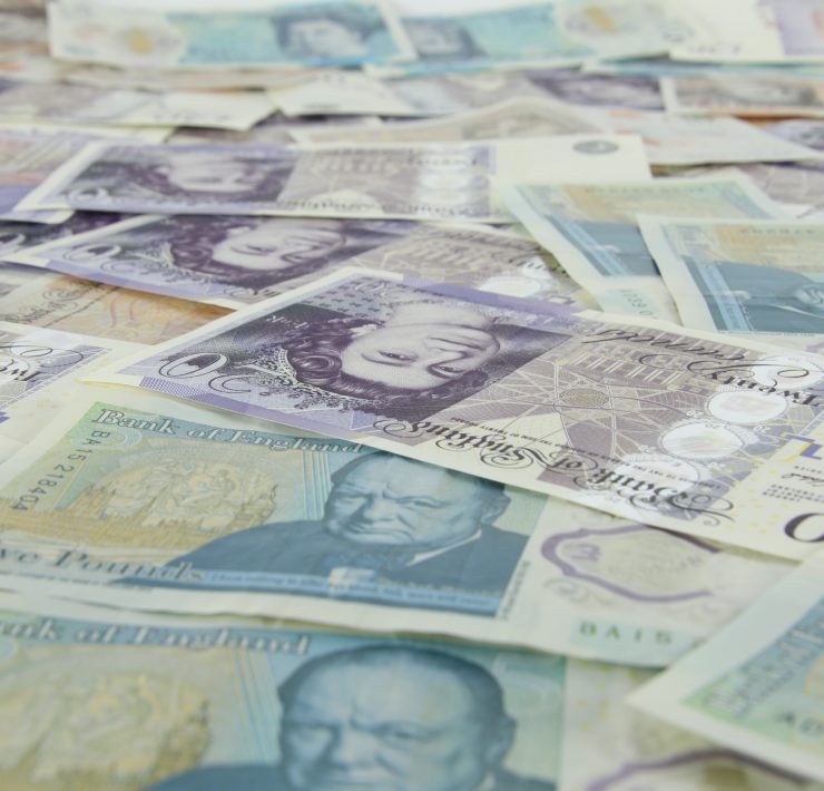 English banknotes spread on a desk