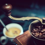 A coffee grinder and a cup of coffee