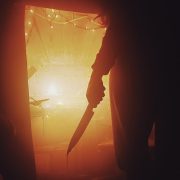 man holding a knife dripping with blood