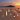 booze bottles on a beach with sunset backdrop