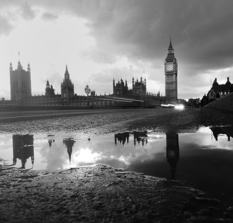 houses of parliament reflected in a puddle