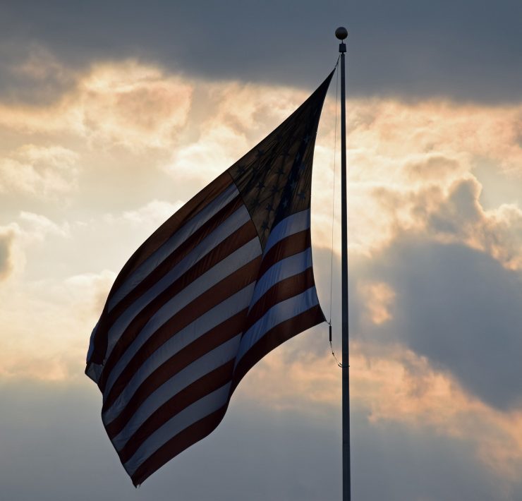 American flag against a sunset