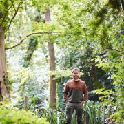 Aldo Kane stood in the woods