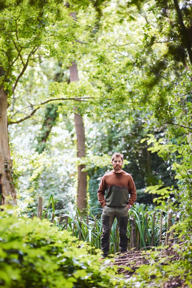 Aldo Kane stood in the woods