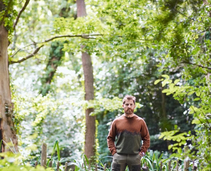 Aldo Kane stood in the woods