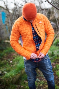 A man zips up a North Face Men's Impendor Thermoball Jacket