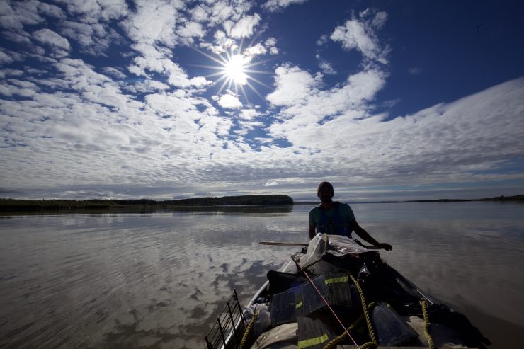 Adam Weymouth paddling his canoe down the Yukon River