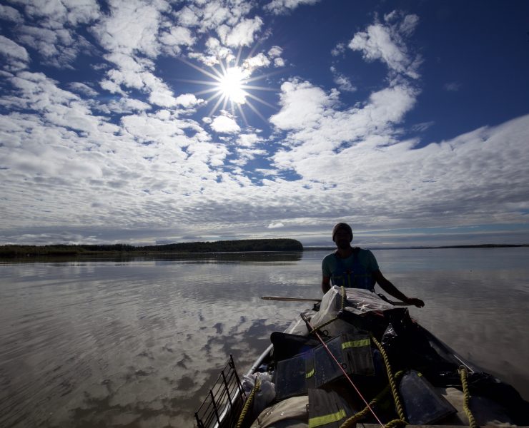 Adam Weymouth paddling his canoe down the Yukon River