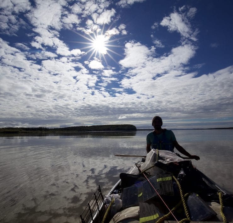 Adam Weymouth paddling his canoe down the Yukon River