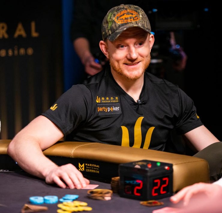 Poker player Jason Koon smiles as he throws chips onto the table
