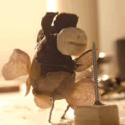 A small puppet playing an instrument