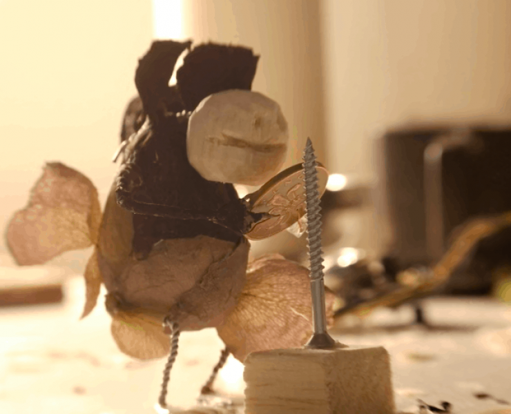 A small puppet playing an instrument