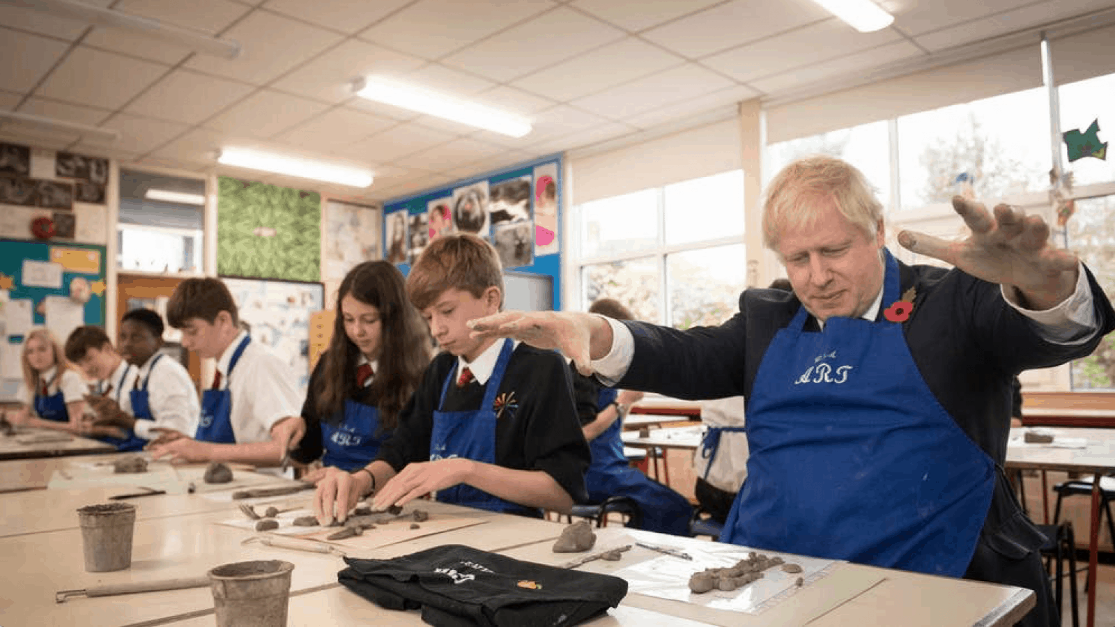 Boris in a classroom playing with clay