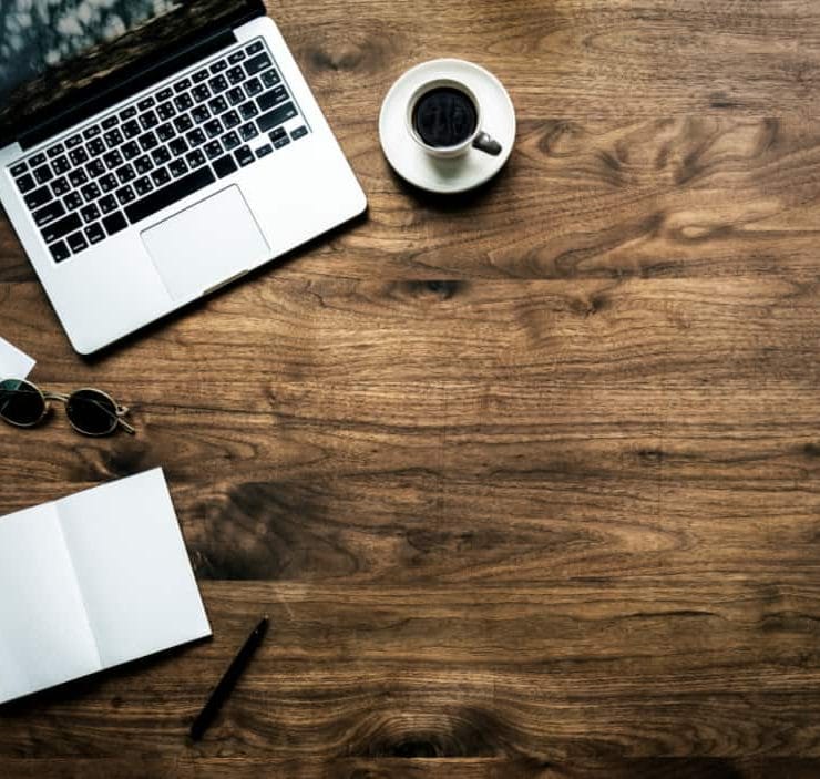 A laptop and mug of coffee on a table
